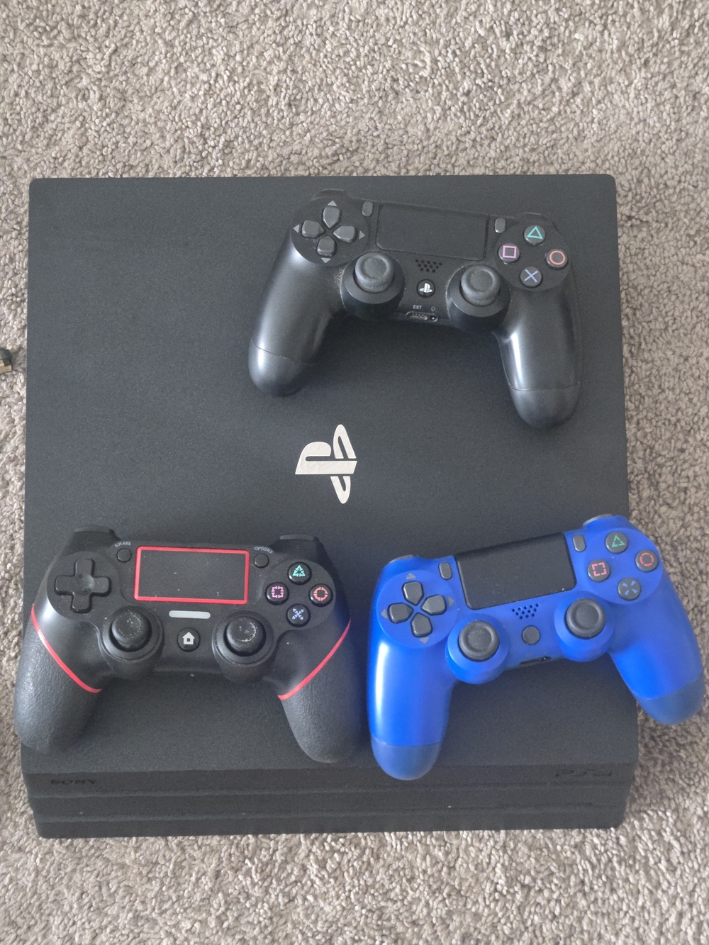 Sony 4 Slim Console with Black, Red-Accented, and Blue DualShock Controllers